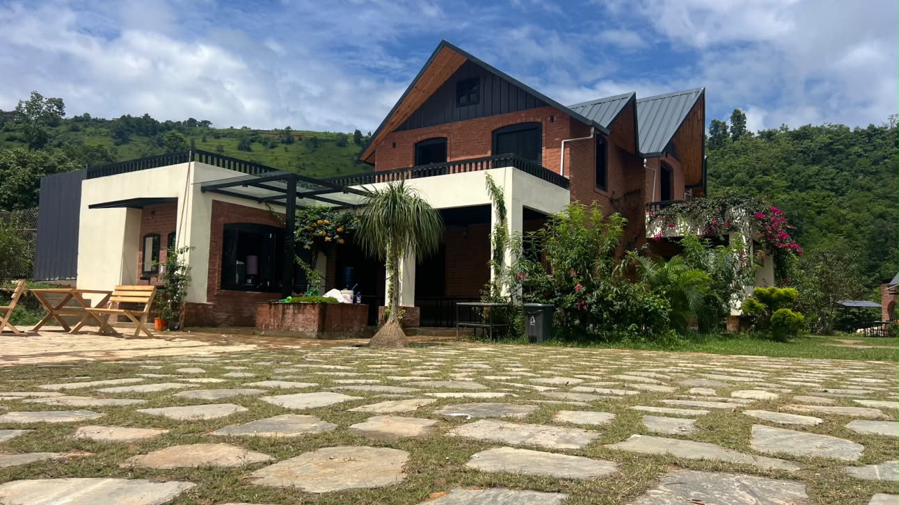 The main lodge and stone courtyard on a bright afternoon
